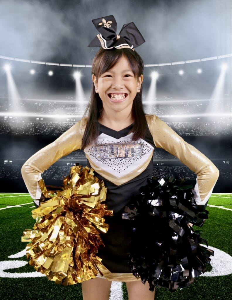 Roselyn in Pop Warner sideline cheer uniform where her all-star cheer journey began