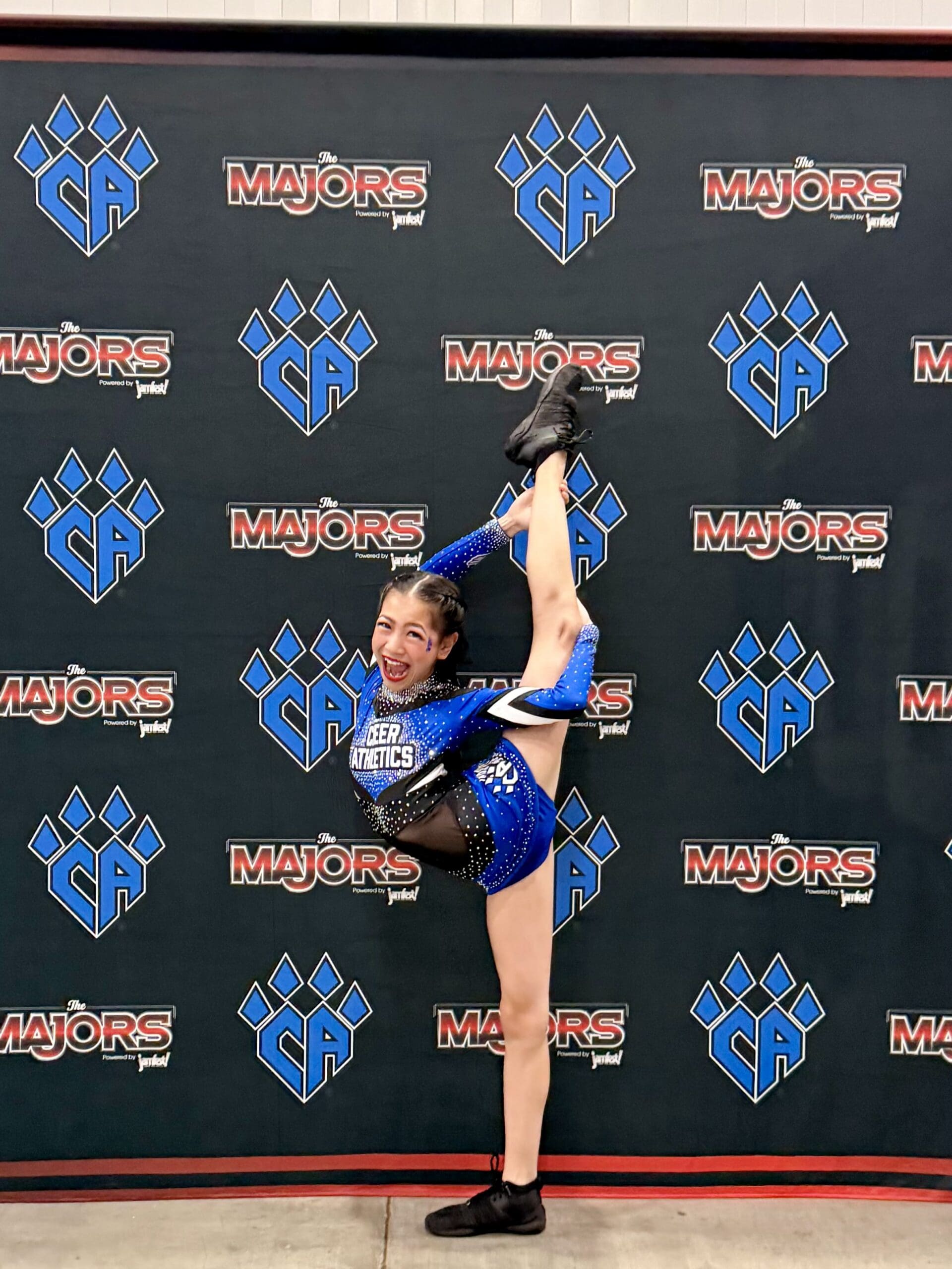 Roselyn performing a needle in her Cheer Athletics Chicago uniform.